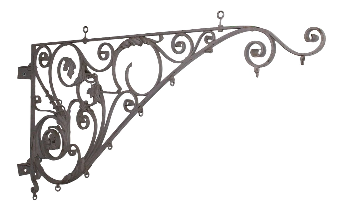 19th Century Wrought Iron Sign Bracket: Elegant and large scale late 19th century painted wrought iron sign bracket having intricate tendril-like scrolled metalwork with floral and foliate motifs. Condition: Alterations: Original Condition