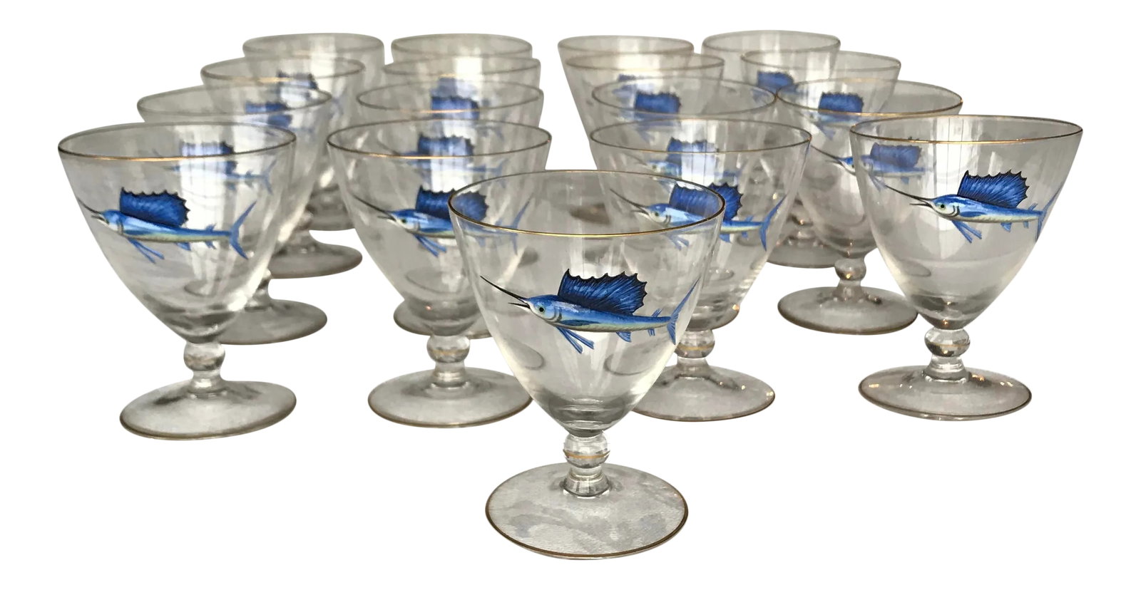 Early 20th Century Bohemian Crystal and Enamel Swordfish Cocktail Gasses - Set of 17: An awesome and unusual set of 17 hand blown crystal Art Deco Sailfish cocktail glasses with raised, molded and hand painted polychrome enamel decoration. Each glass is uniquely decorated and trimmed
