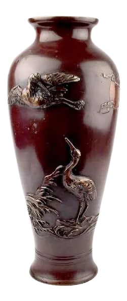Antique Japanese Meiji Era Bronze Crane Vase: Japanese Meiji Era bronze Crane vase, one flying crane amid moon and stylized clouds, one walking crane amid river plants in bas-relief, various alloys. Intact original patina. Circa late 19th century