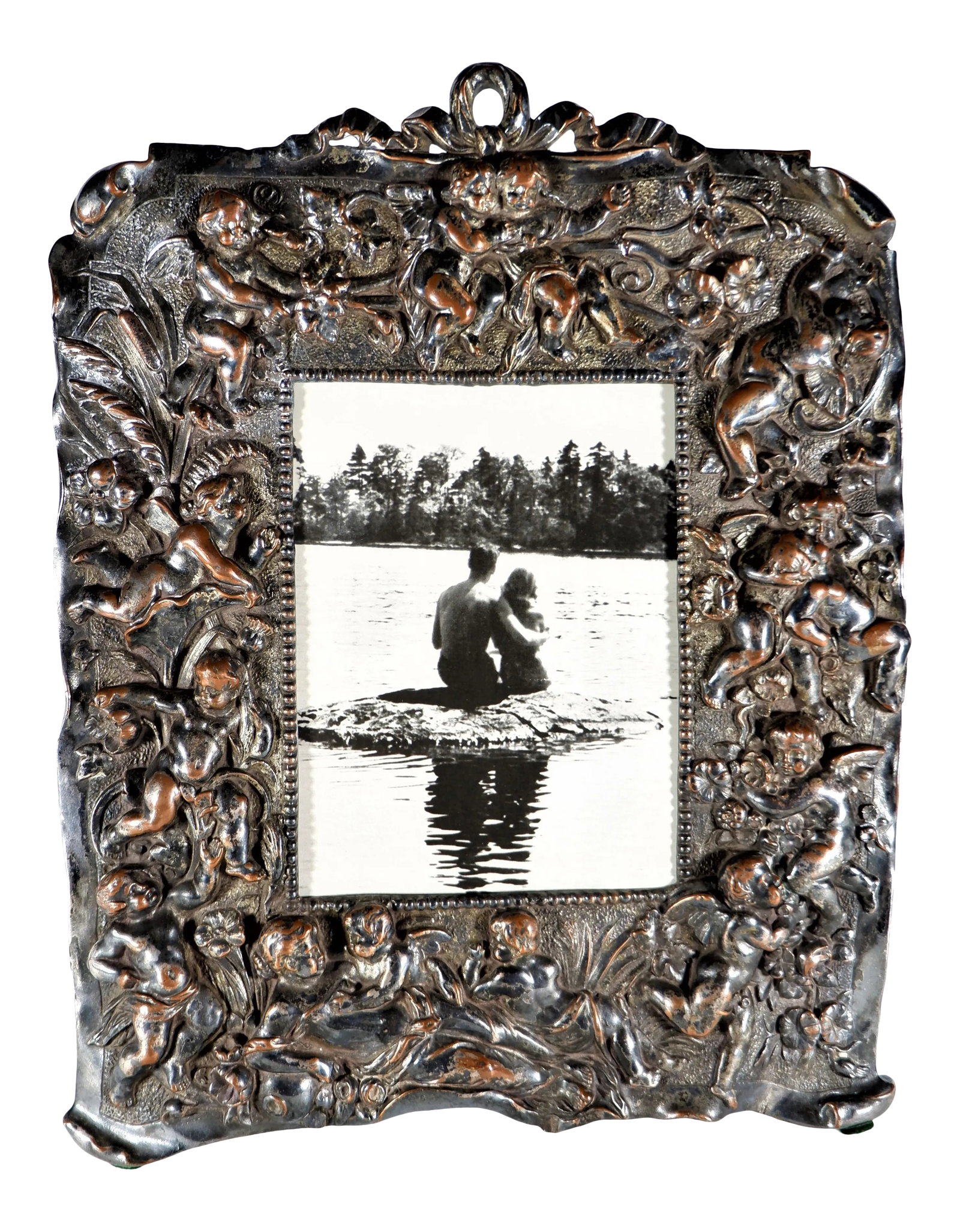 Antique Silver Over Copper Table Frame With Cherubs: An antique Victorian silver plate over copper table frame. Frame has numerous repose cherubs. Copper showing through in areas giving it a warm glow. Measures 11 1/2" high and 9" wide. Good antique con