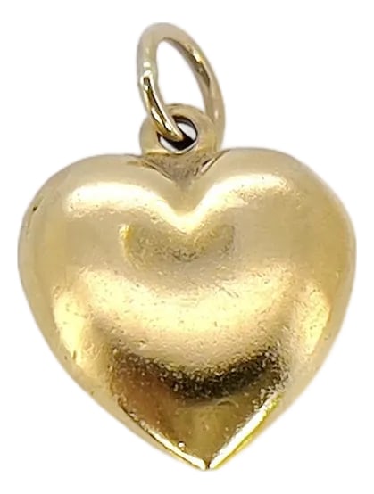 Vintage 9k Gold Puffy Heart Charm: About This Charm: Add a vintage twist to your outfit with our Vintage Puffy Heart Charm. Crafted around the 1970s, this 9K gold charm features a vibrant gold color that adds a touch of femininity to a