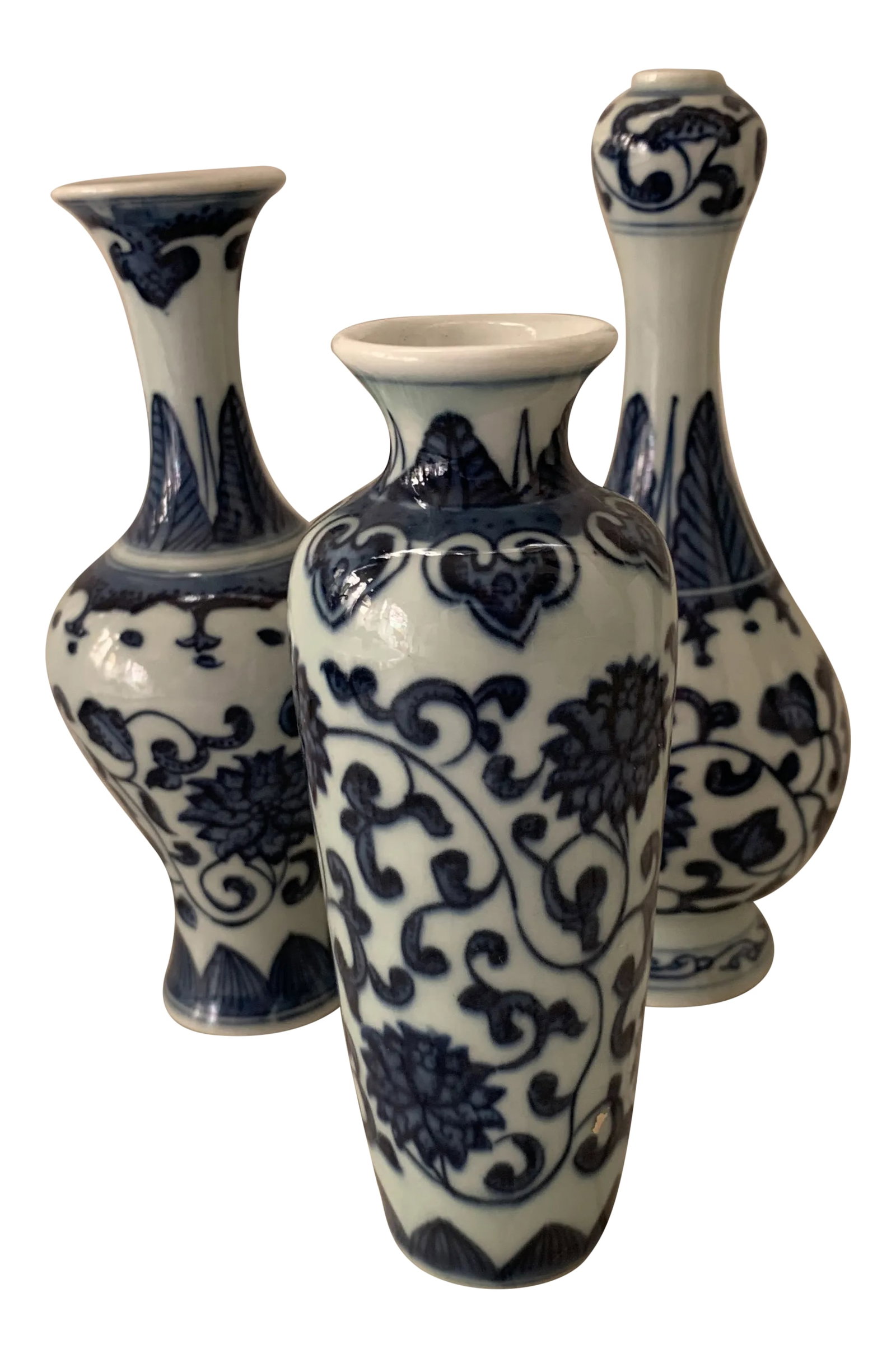 Blue & White Porcelain Floral Chinoiserie Vases Set of 3: A curated set of three Blue & White Porcelain Chinoiserie Vases Measurement is for the tallest vase. Shortest vase measures 5"H x 2 x 2". Condition: Alterations: Original Condition Unaltered