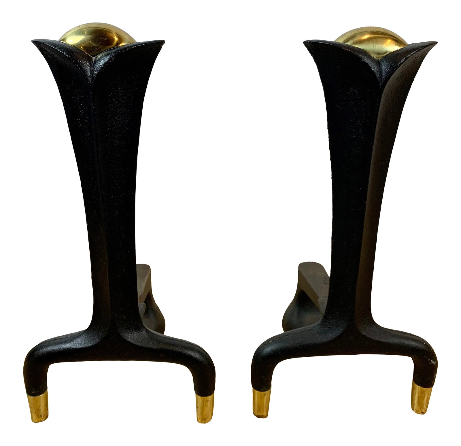 MId-Century Donald Deskey Iron and Brass Andirons - A Pair: A pair of mid-century modern andirons attributed to Donald Deskey (1894-1989), featuring a bold architectural form crafted in cast iron with elegant brass ball finials and brass-capped feet. The sleek