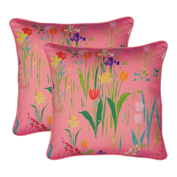 Paule Marrot Guermantes Pillows, Pair: This decorative pillow features one of Paule Marrot's most beloved designs, with a vibrant field of flowers and grasses set against a lively coral pink ground. The painterly composition brings color, 