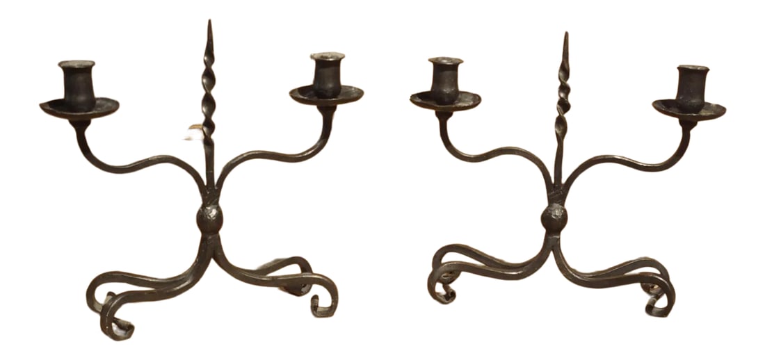 Pair of Early 1900s Forged Iron Candleholders From France: This pair of forged iron candleholders was produced in France in the early 1900's. The two holders have slightly different dimensions, indicating that they were crafted by hand. Each candleholder has