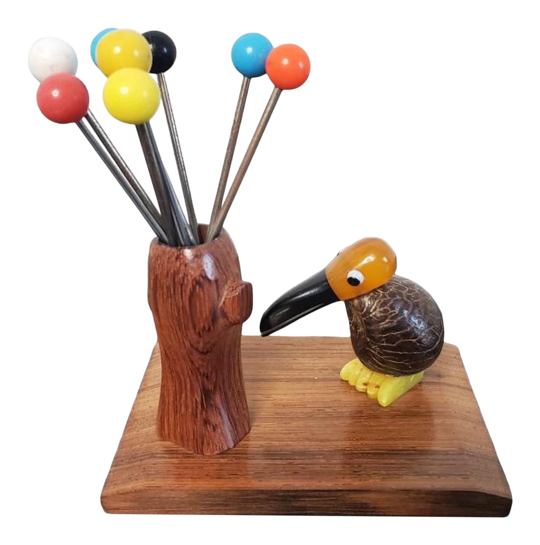 French Art Deco Bird Mounted Cocktail Stick Holder: A fabulous 1930s Art Deco period figural cocktail stick set. Born in France, featuring a sculptural silhouette depicting a most unusual stylized Toucan bird standing beside a hollow tree trunk,