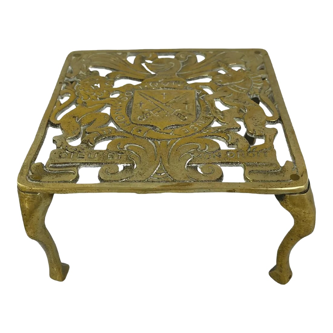 Antique Brass Trivet: Antique solid brass trivet with family crest motif. No maker's mark. Minimal age wear. Condition: Alterations: Original Condition Unaltered Imperfections: Some Imperfections Condition Notes: Minimal a