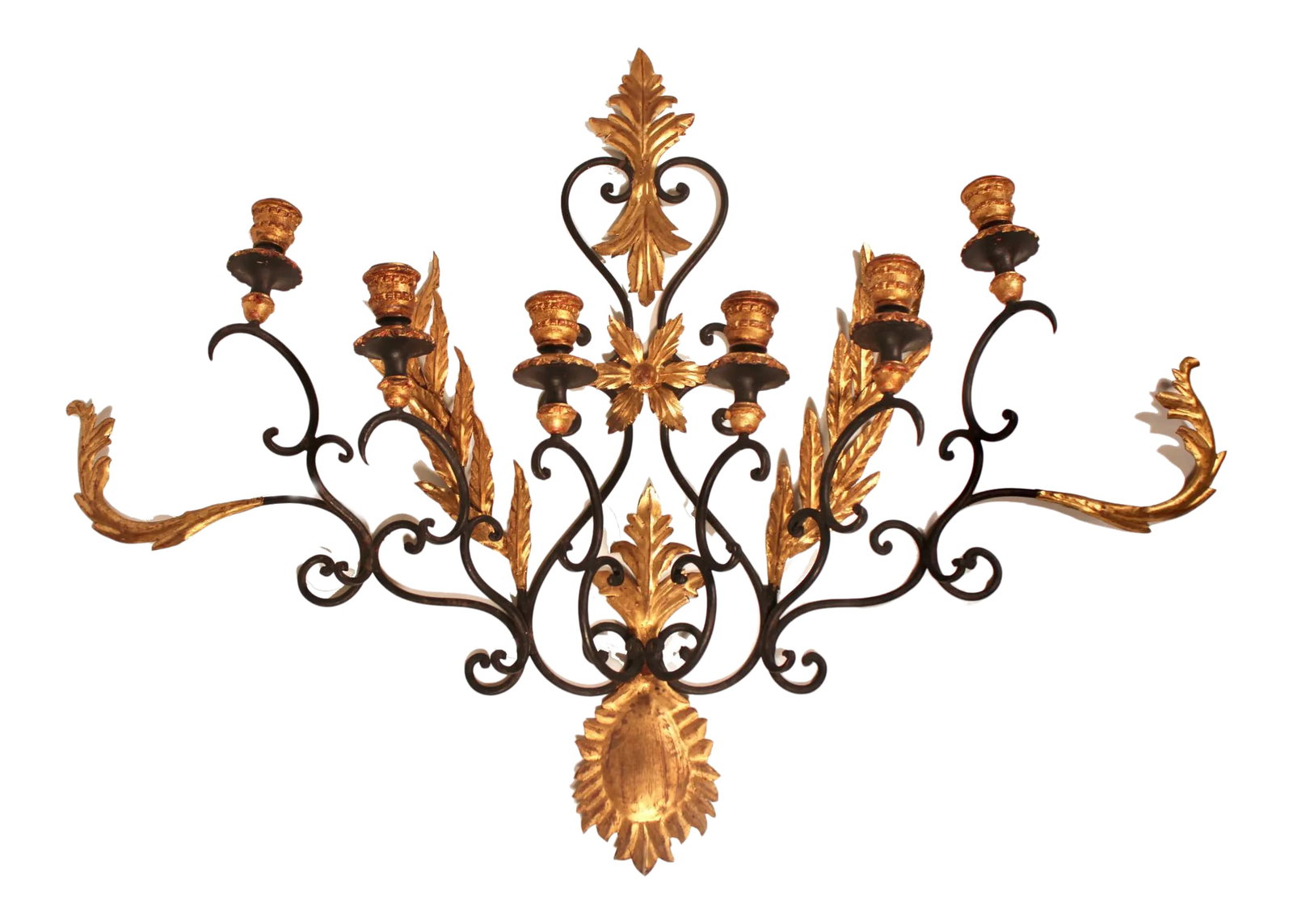 Mid Century Italian Black and Gold Metal and Tole Wall Sconce: A stunning mid century gold leaf tole and sculpted metal Italian wall sconce tagged, "made in Italy." This is a superb wall sconce that is large in size and would look lovely over a bed or mantle.