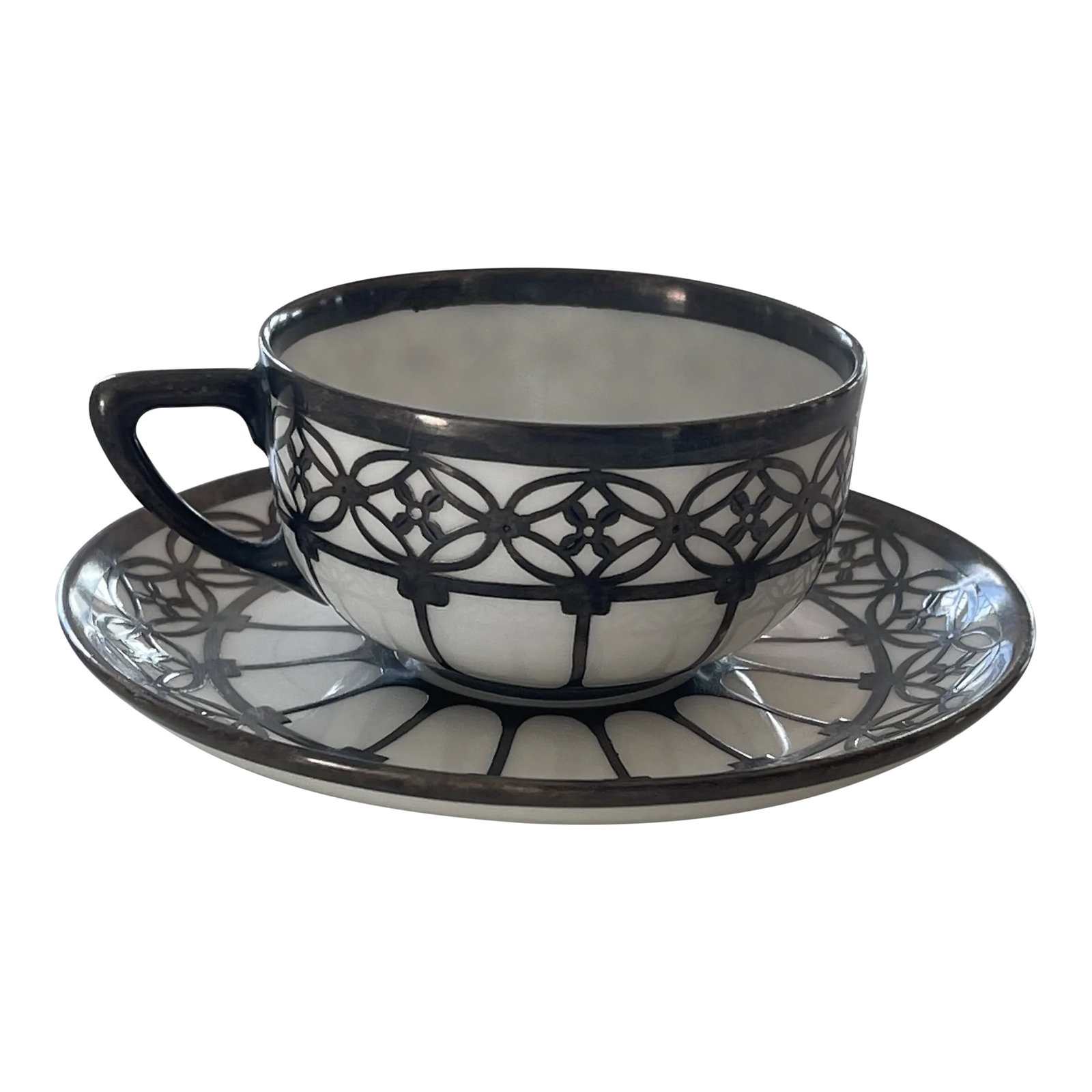 Early 20th Century Rosenthal Selb Bavaria Demitasse Silver Onlay Cup and Saucer Set- 2 Pieces: Philipp Rosenthal started doing business in the porcelain industry in 1884 roku in Erkersreuth situated near Bavarian Selb. This porcelain and silver demitasse or mocha cup and saucer was produced in