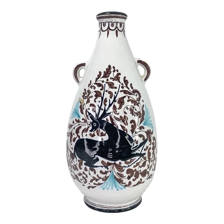 1970s Italian Ceramic Handpainted Handled Deer Vessel: This vintage hand-painted handled stoneware pottery jug vase, crafted in Italy and marked "CACF Faenza" on the bottom, is a charming piece of artistry. It depicts a scene with deer, showcasing the cra