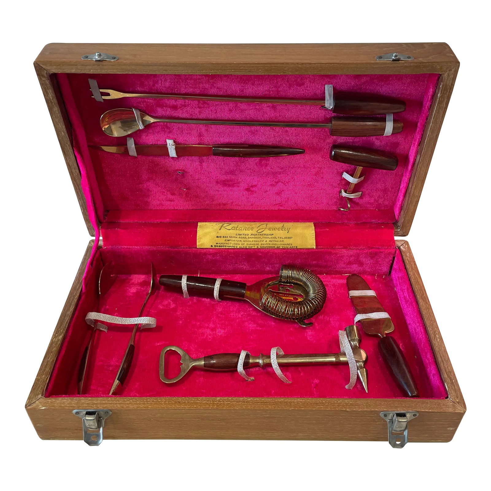 1940s Vintage Wood and Brass Bar Service Set From Thailand- 8 Pieces: Handcrafted vintage 8 piece bar set from Thailand contained within a custom wood box lined with red/pink velvet. Set was created by Ratanee Jewelry of Bangkok, Thailand. Each brass piece was uniquely 