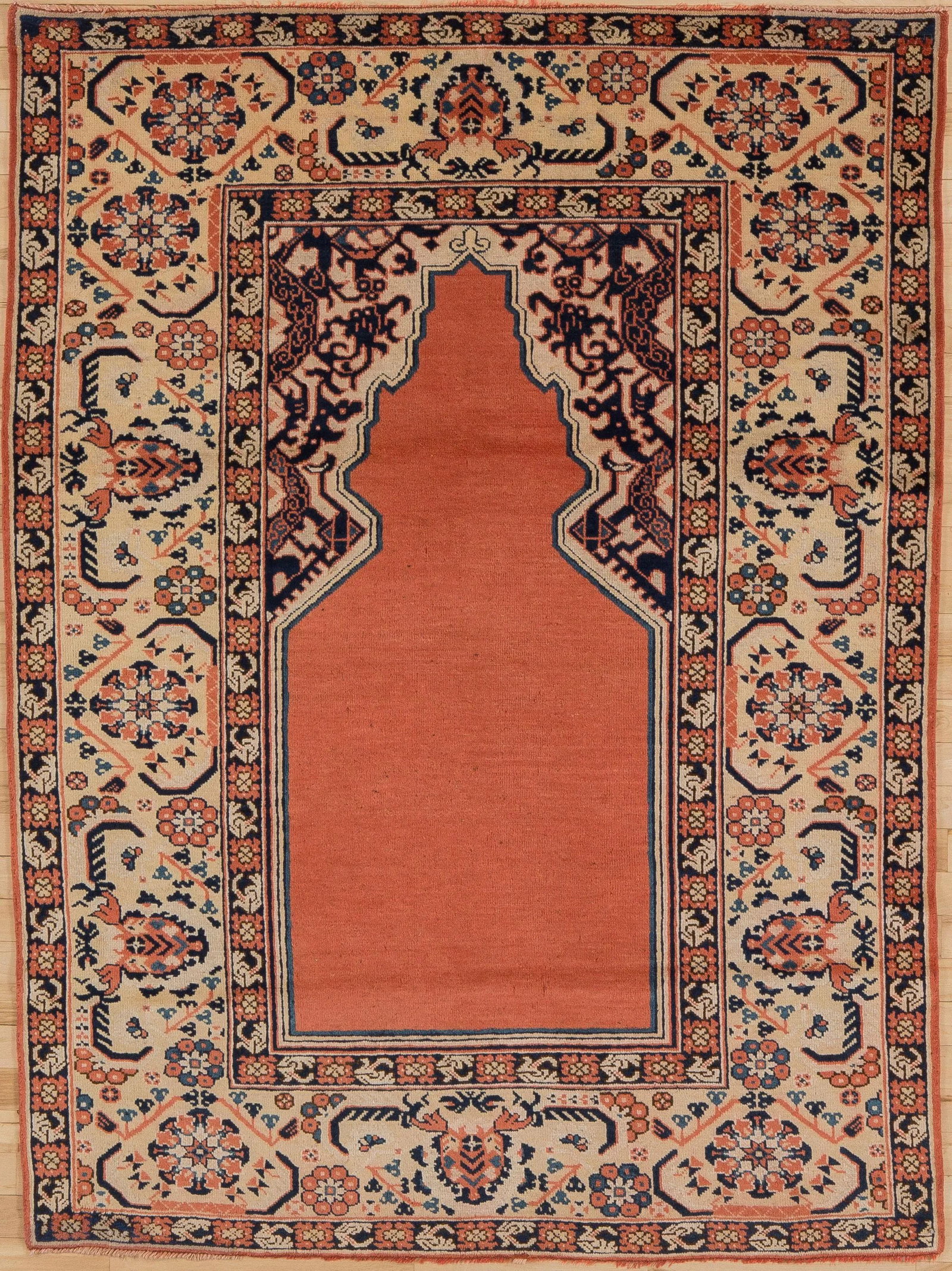Early 20th Century Antique Khotan Prayer Rug - 4' * 5'6'': Can't afford a genuine 17th century Transylvanian rug ?This close copy from Khotan in the early 20th century has all the features of a classical rug:open,plain light red field;yellow spandrels with