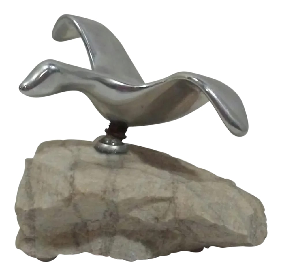 Mid Century Canadian Sculpture Steel Articulated Bird in Flight Stone Base Signed: A Mid Century table top sculpture of an aluminum or steel bird in flight with a pivoting stand on a natural granite base. Signed under wing Hoelfsten? Canada. Overall 5.5" L x 4.5"W x 4.5"H.