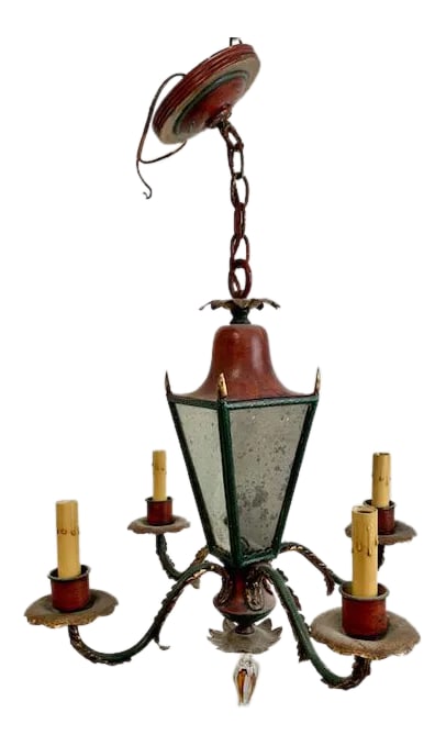 Vintage Italian Mirrored Glass Chandelier: This vintage Italian chandelier is a rare and distinctive piece, featuring mirrored glass panels framed within a lantern-style body. Six scrolling arms extend outward, each fitted with candle-style li