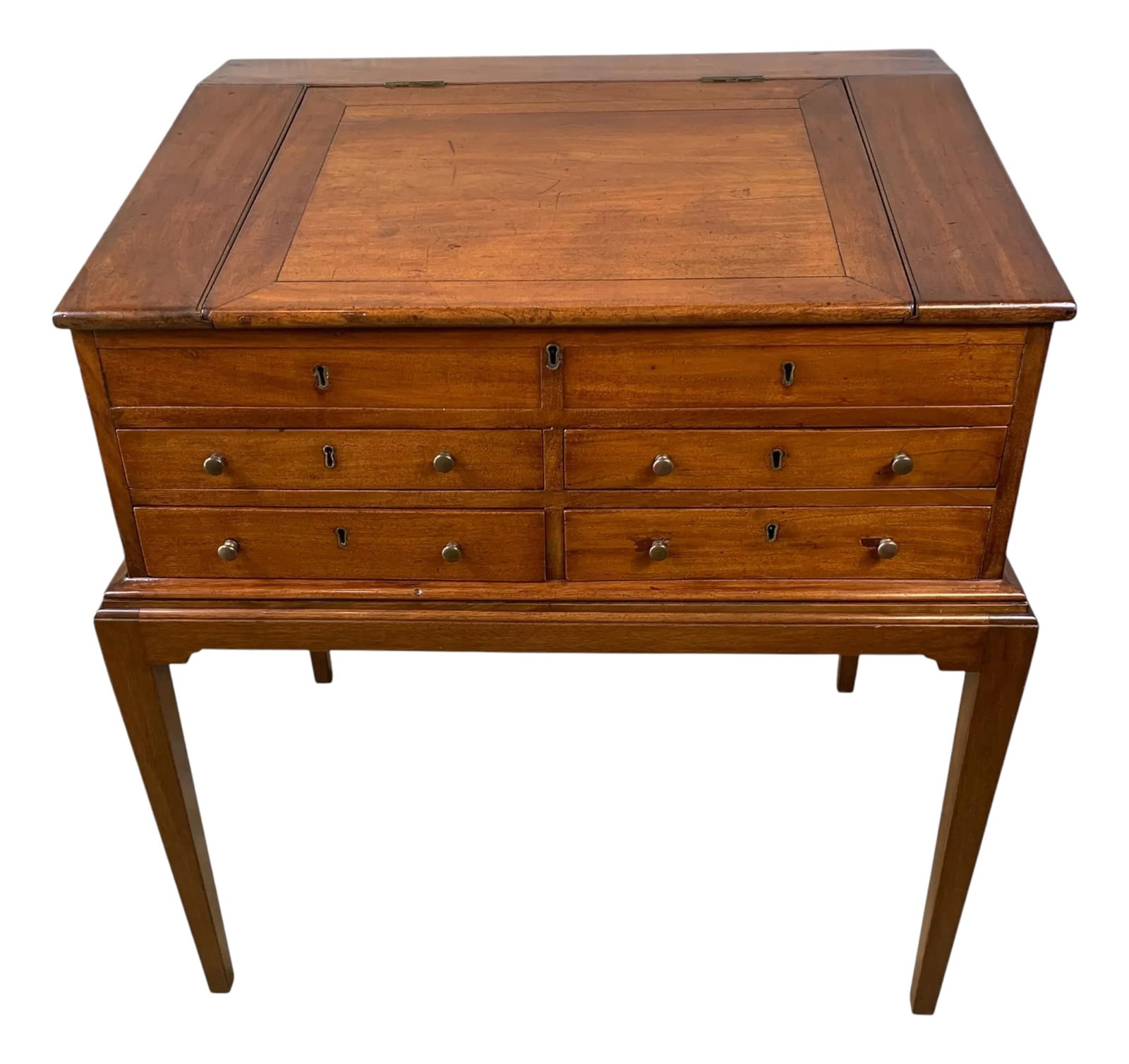 Antique English Slant Front Mahogany Desk on Stand: Mid 19th century, mahogany, English Victorian Slant Front Desk in two pieces. The desk features two faux drawers over four dovetailed drawers with brass pulls. Overall, this piece is in very fine cond
