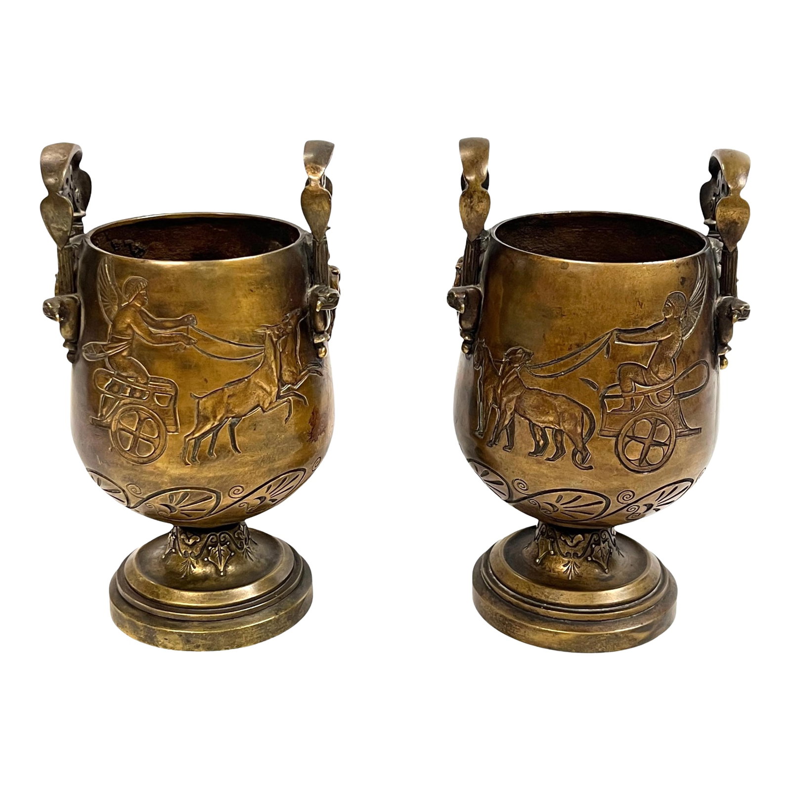 Pair 19th Century Egyptian Revival Bronze Vases: Pair of antique (19th century) bronze vases from the Egyptian Revival period depicting chariots pulled by leopards on one side, and stag-led chariots on opposite side with handles depicting male masks