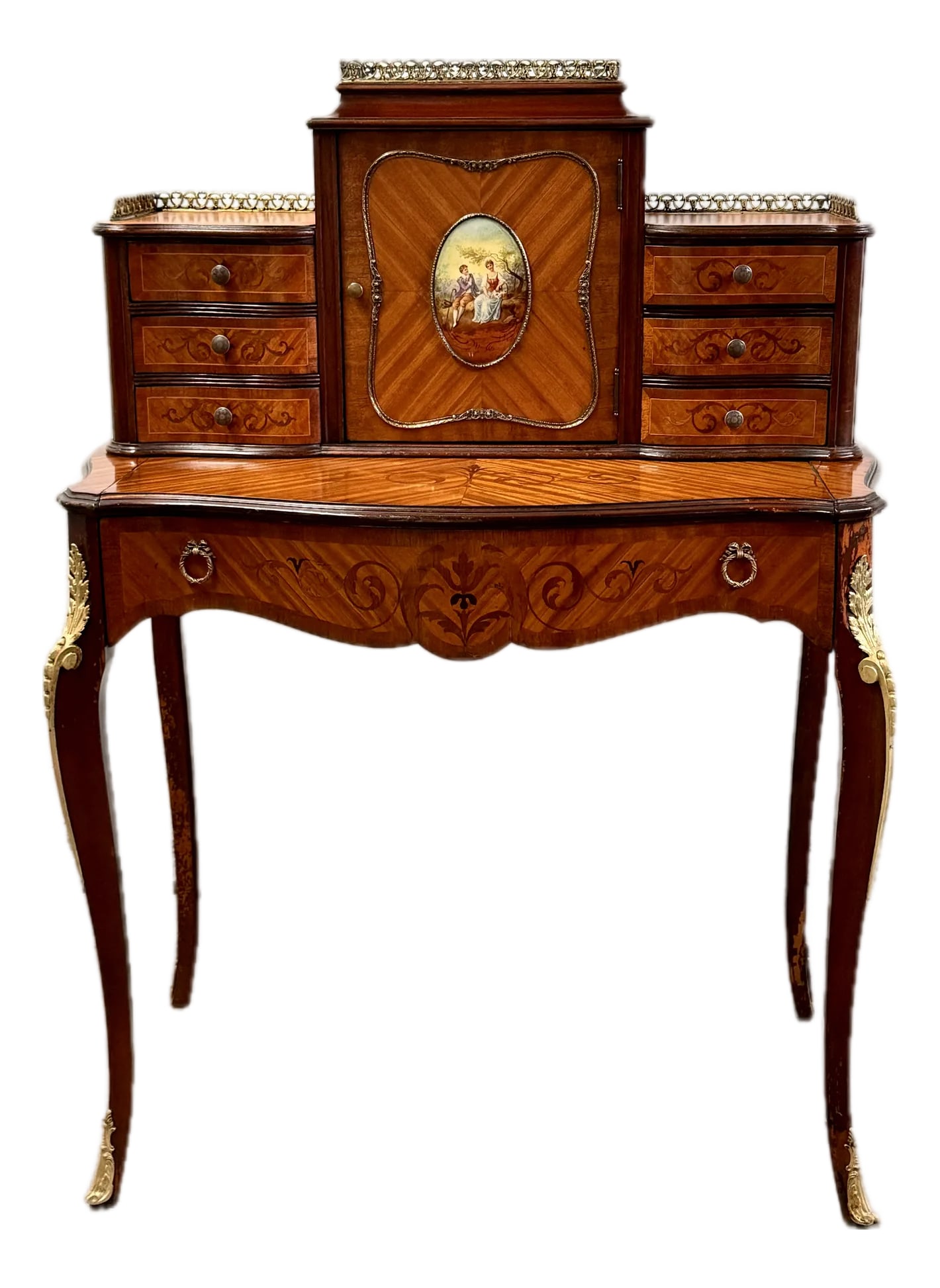 Antique Inlaid Ladies Desk: Antique inlaid ladies desk with applied bronze and gallery ormolu on the legs. The door containing one shelf; 6 drawers. Made by Leonardo Furniture, New York, NY. Writing surface 19" x 27". Condition: