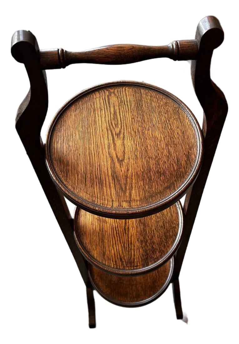 1900s Edwardian Mahogany Antique Cake Stand: Add a touch of vintage charm and practical versatility to your home with this delightful 3-tier folding wooden display shelf. This charming piece is perfect for showcasing your favorite collectibles,
