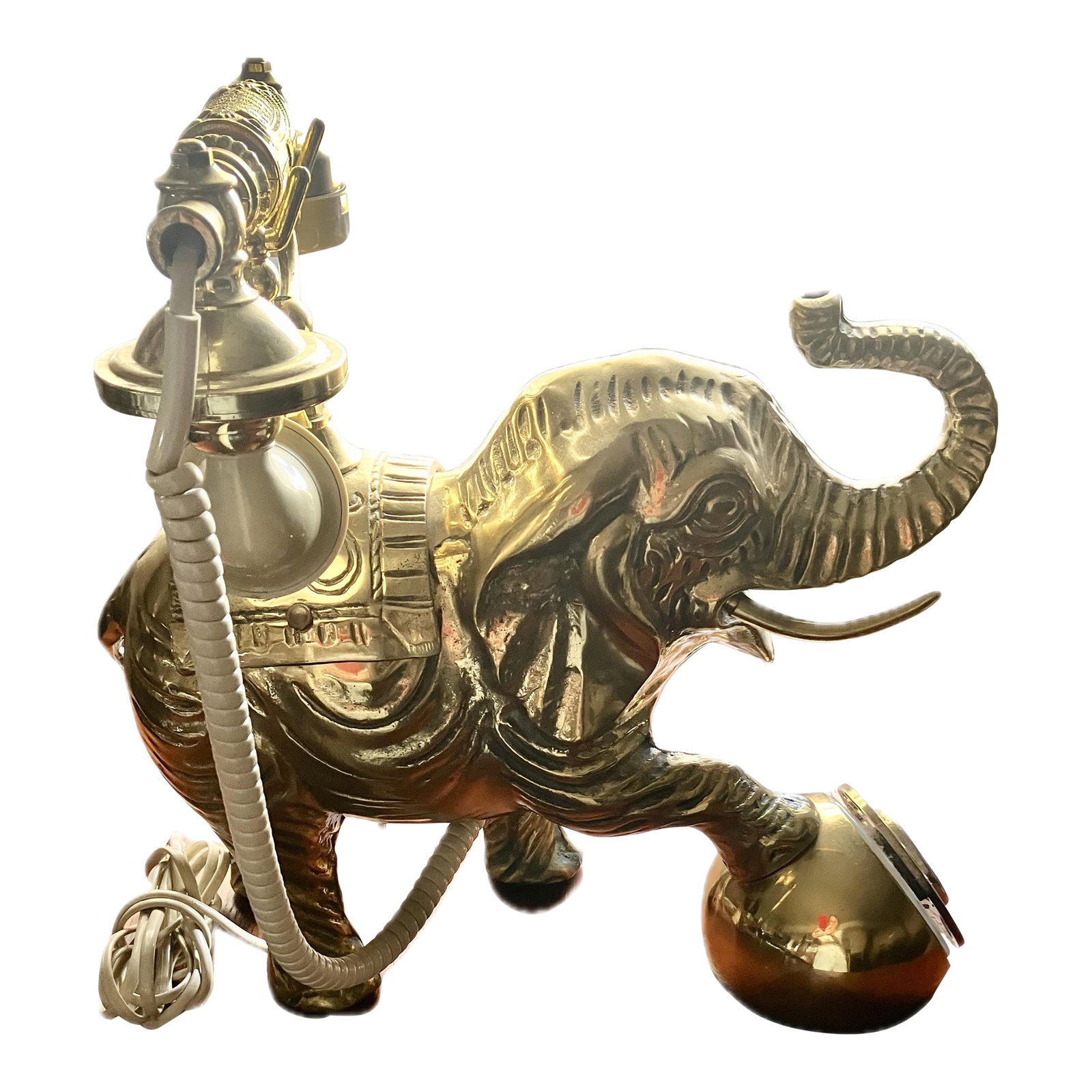 1950s Vintage Hollywood Regency Heavy Cast Brass Elephant Desktop Rotary Telephone Decor: This is a vintage cast brass elephant telephone, from the Midcentury Modern period. It features a cast brass elephant as the base, with a rotary dial often integrated into one of its legs, and a