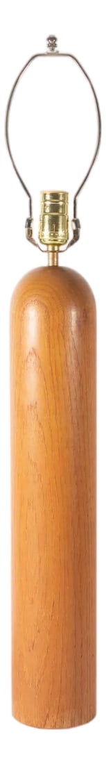 Mid Century Modern Teak Wood Table Lamp: A Mid Century Modern teak wood table lamp. The cylindrical wooden lamp has a sleek minimal design and a rounded top. Unmarked, the lamp has a white cord. Condition: Alterations: Original Condition Una