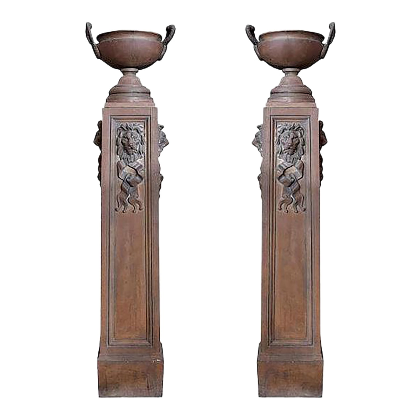 Mid 19th Century Pair of Cast Iron Pedestals With Urns and Lion Detail: Said to have come from a Scottish castle, these are excellent cast iron pedestals featuring urns and lion head detail on three sides. The lion's head detail features a wreath-like ribbon below the