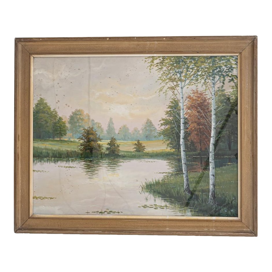20th Century French Landscape Painting With Gilded Wood Frame: This 20th Century French landscape painting captures a tranquil countryside scene, featuring a reflective pond surrounded by trees in soft hues of green, amber, and rust. The composition is bathed in 