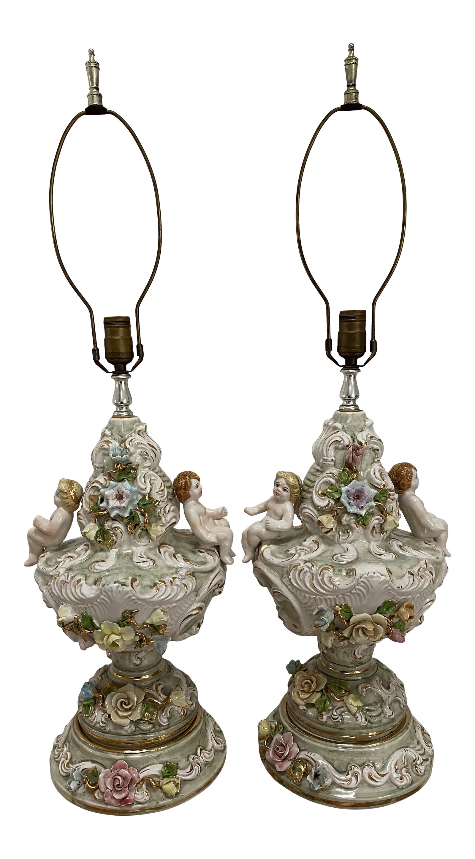20th Century Italian Capodimonte Porcelain Lamps - a Pair: A truly exquisite and unique pair of Italian Capodimonte porcelain lamps. Circa 1940s this pair features intricately decorated designs presenting a vibrantly colored porcelain exterior. Detailed with