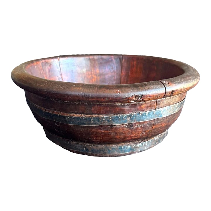 Compact Antique Chinese Wooden Basin With Iron Bands: This antique Chinese wooden basin is constructed from thick, hand-hewn staves bound with forged iron bands, creating a form that is both functional and powerfully sculptural. The surface shows deep,
