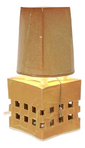 Contemporary One Police Plaza Lamp: A study in geometric restraint, the 1PP Lamp combines a brutalist cubic base with a graceful tapered shade. The 5" * 5" * 5" base features a grid of precisely cut openings that transform the