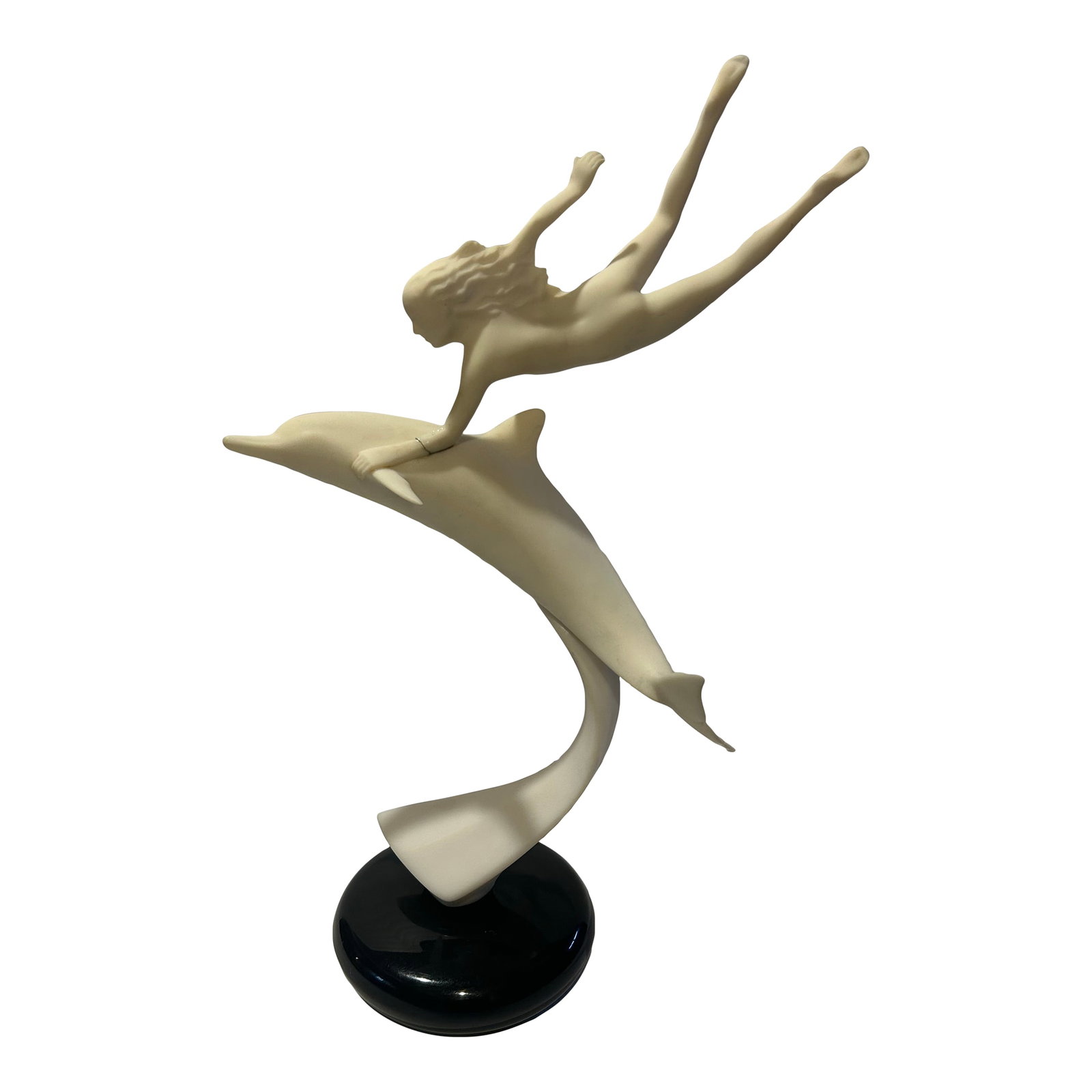1984 John Perry Lady & Dolphin Sculpture: Graceful vintage sculpture captures a nude female poised on top of a dolphin. Soft ivory tone mounted on a contrasting black base. Would make a beautiful decorative object for a table or shelf.