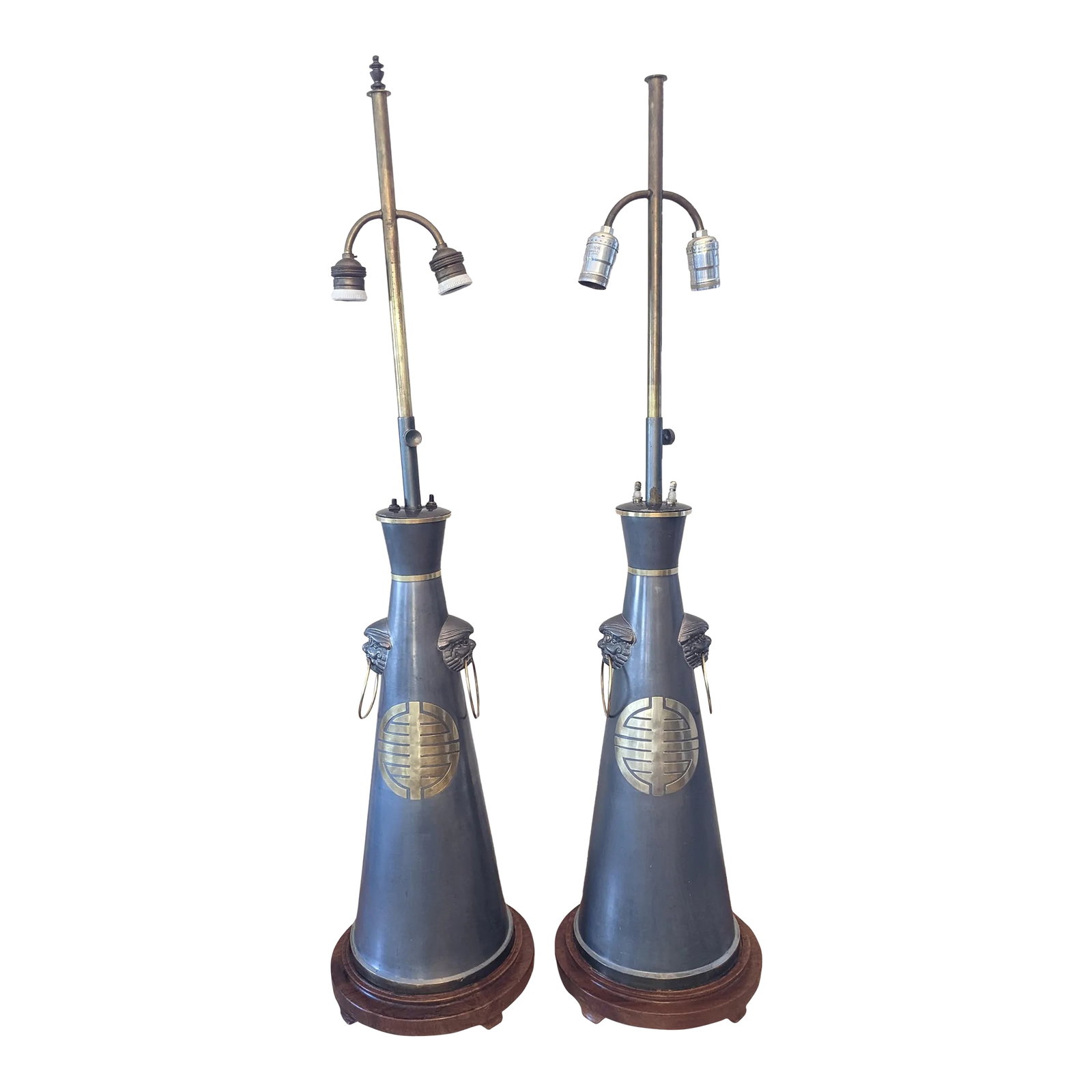 Pair of 1940s Hollywood Regency/Chinoiserie Style Pewter Lamps: Pair of large pewter Chinoiserie lamps with brass medallions, foo dog embellishments, and wooden bases. Likely made in the 1940's or 50's. No maker's mark visible, very similar in style to Marbro