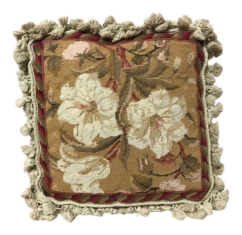 Vintage Needlepoint Pillow: Vintage needlepoint pillow. Front panel is done in a wool needlepoint and depicts a group of off-white flowers on a tan background. Raspberry, green and gold also accent this interesting pillow. The