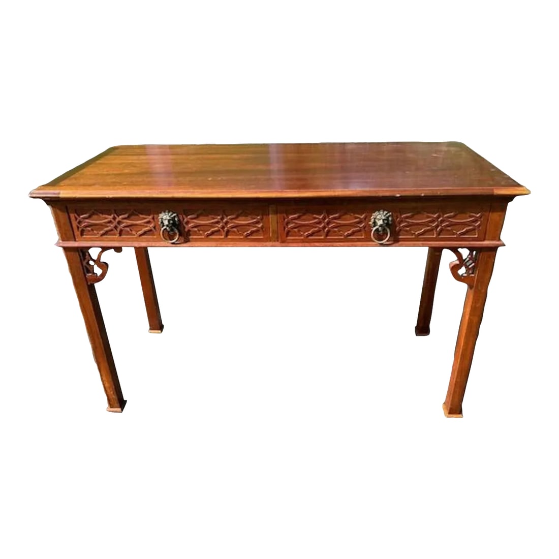 1980s Baker Historic Charleston Mahogany Fretwork Lion Head Two Drawer Desk: This is just a gorgeous Chippendale Desk. It features front fretwork and fretwork corner detailing. The two drawers are adorned with lion heads. The desk interior is clean with the Baker Fine Furnishi