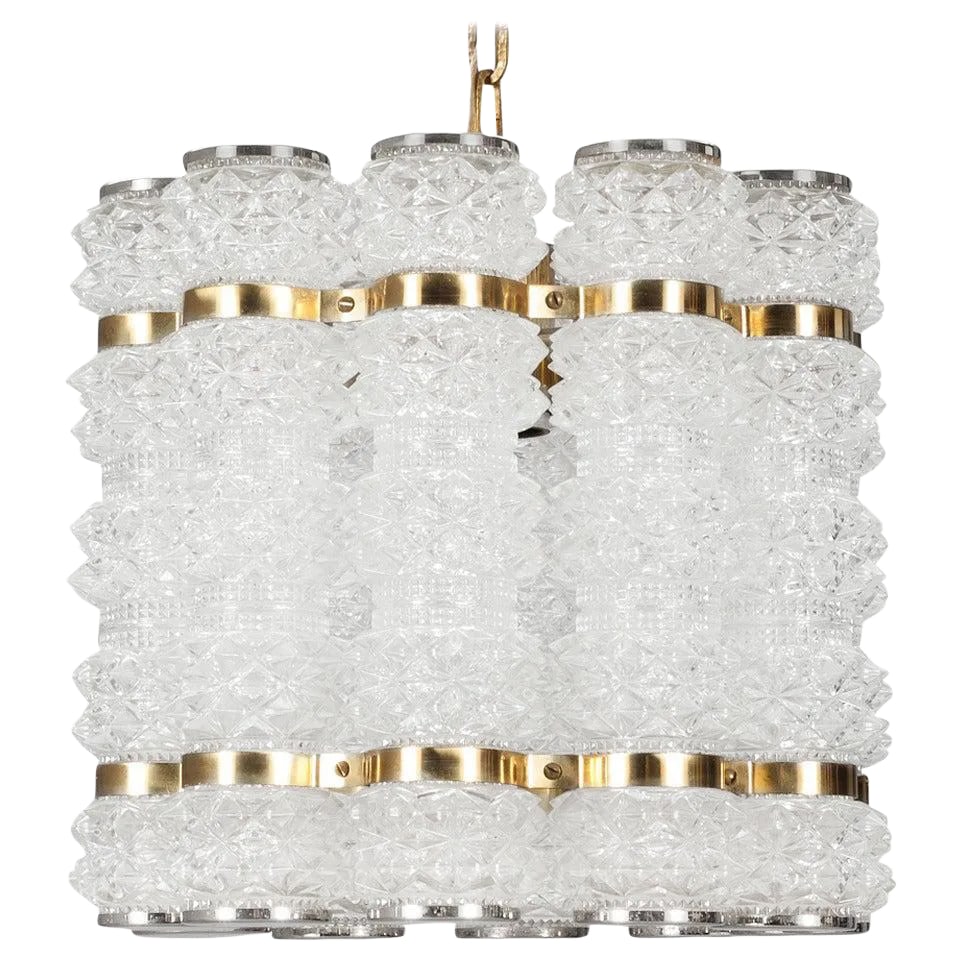 Swedish Pendant: A Pendant by Konst Hant Verk Tyringe, Sweden. Circa 1960th-70s. Glass probably by Orrefors. Cut glass , polished nickel and brass. Glass H-9" ; Drop - 52cm. (20.5") Existing European wiring, re-wiring