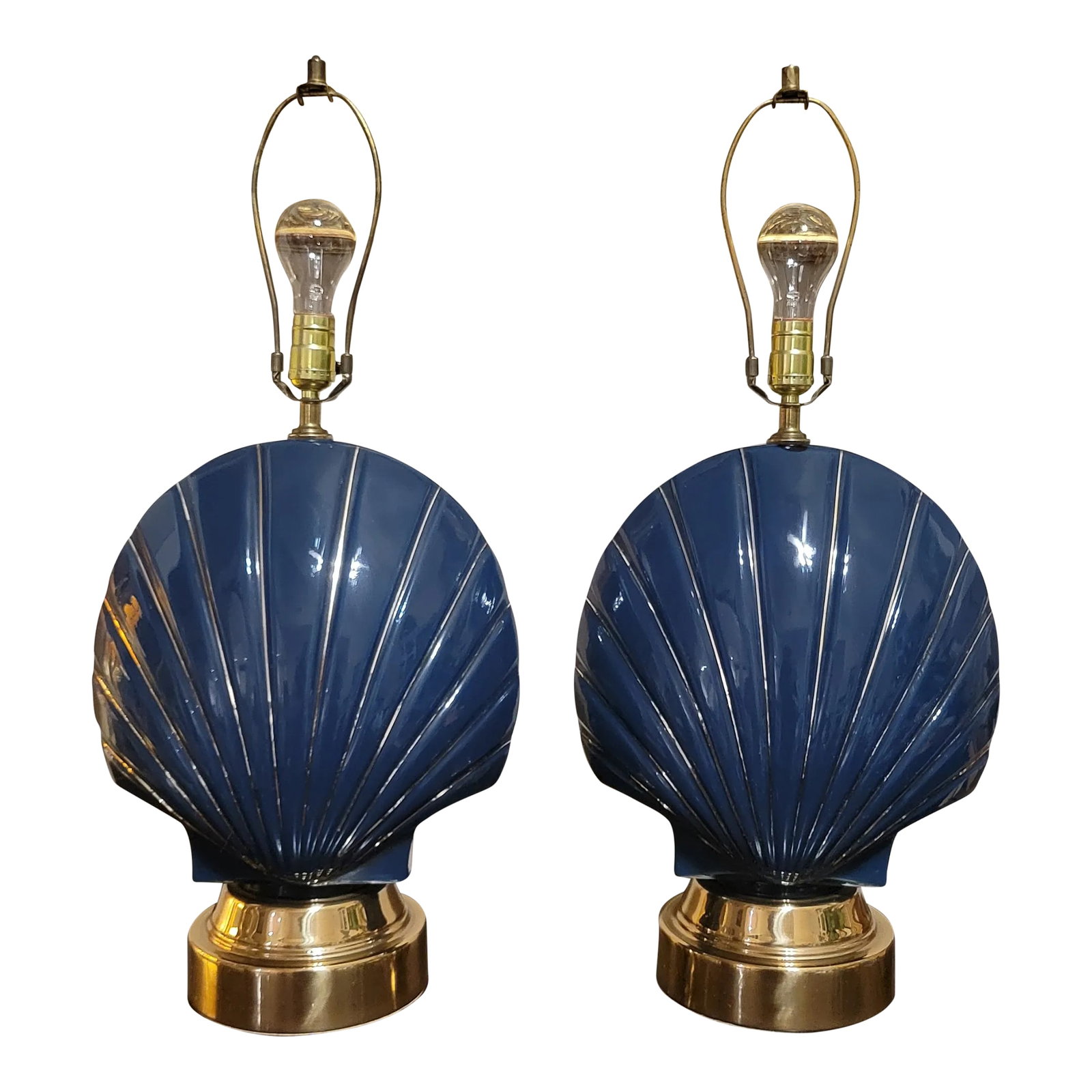 Vintage Pair of Ceramic Seashell Lamps: Rare find, beautiful pair of seashell shaped table lamps, they are of glazed ceramic in indigo blue with golden ribbon and round brass base. Condition: Alterations: Original Condition Unaltered
