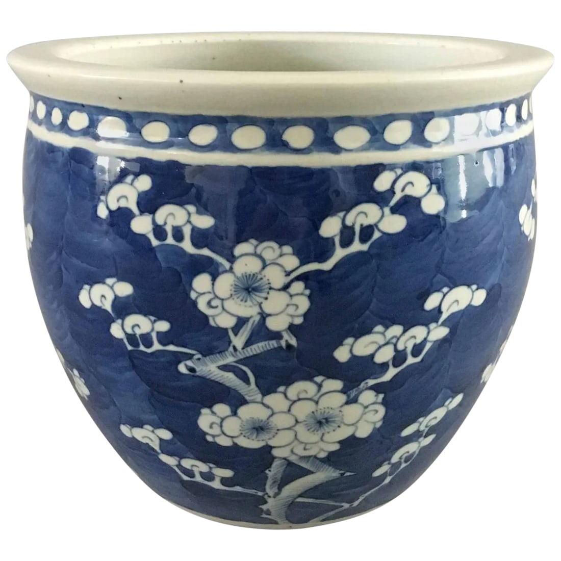 Chinese Export Blue and White Jardiniere: Chinese Export porcelain blue and white jardiniere decorated with prunus branches and blossoms, against a brilliant underglaze cobalt blue background, with a four-character mark to the base. Condition