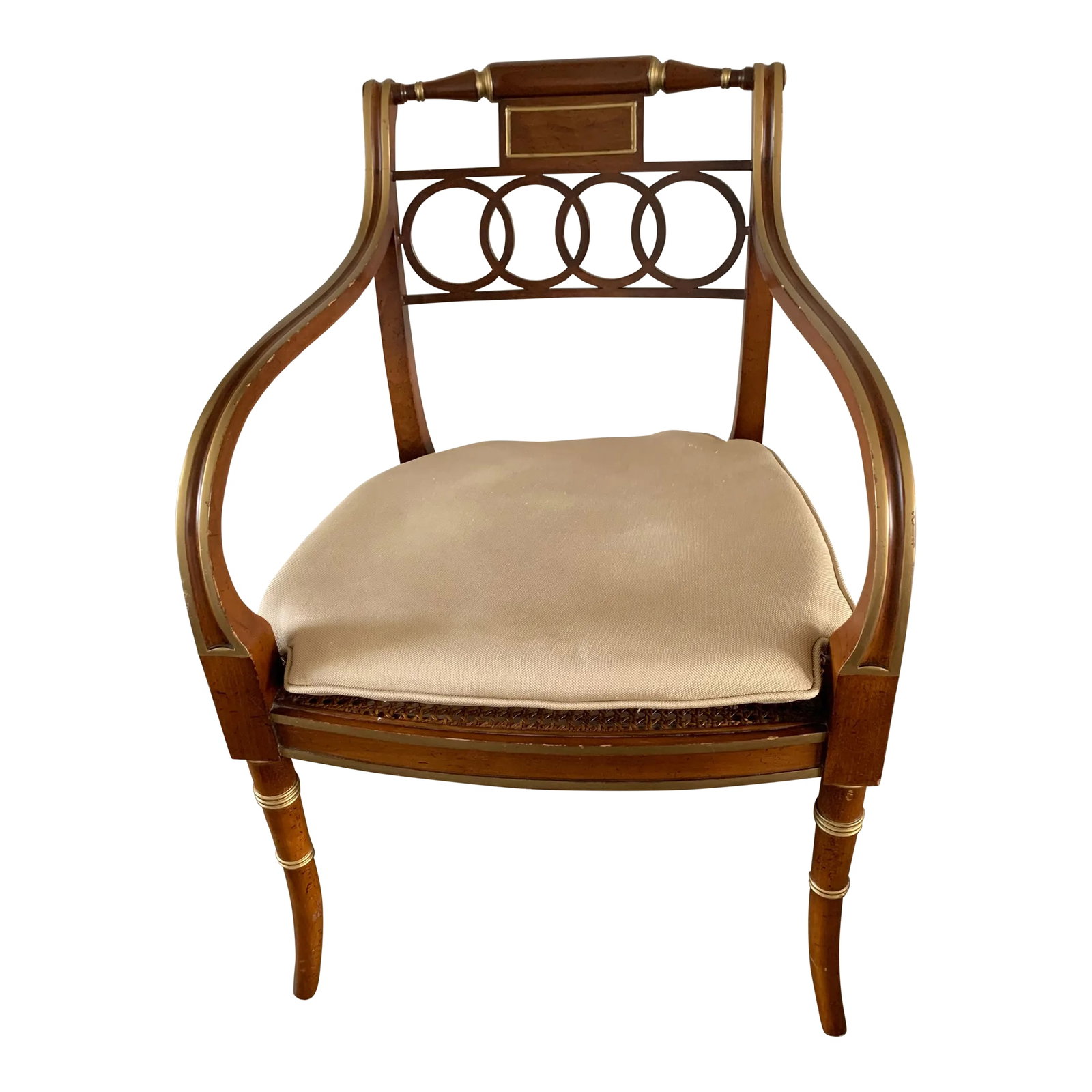 1980s Baker Furniture Hollywood Regency ArmChair Gilt Accents Caned Seat: High end Baker Furniture Hollywood Regency Open Arm Chair, with gilded highlights, on interlocking rings with downward arms resting on saber legs. The frame is well made,, sturdy construction, in a wo