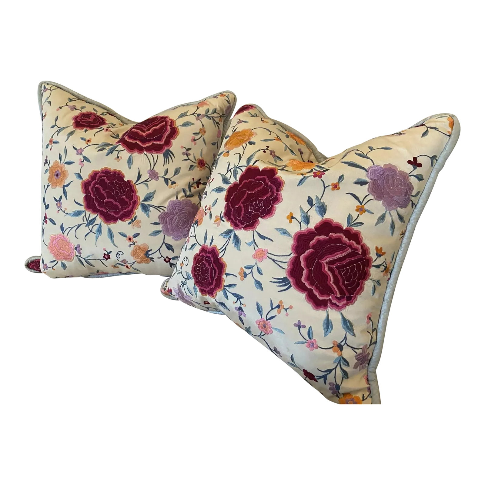 Early 20th Century Chinese Silk Floral Embroidered Pillows- Set of 2: Pillows made from an antique Chinese silk floral embroidered shawl. The colorful embroidery is beautifully executed. Cream background, with a blue dupioni silk backing. Zipper closure. Down inserts in