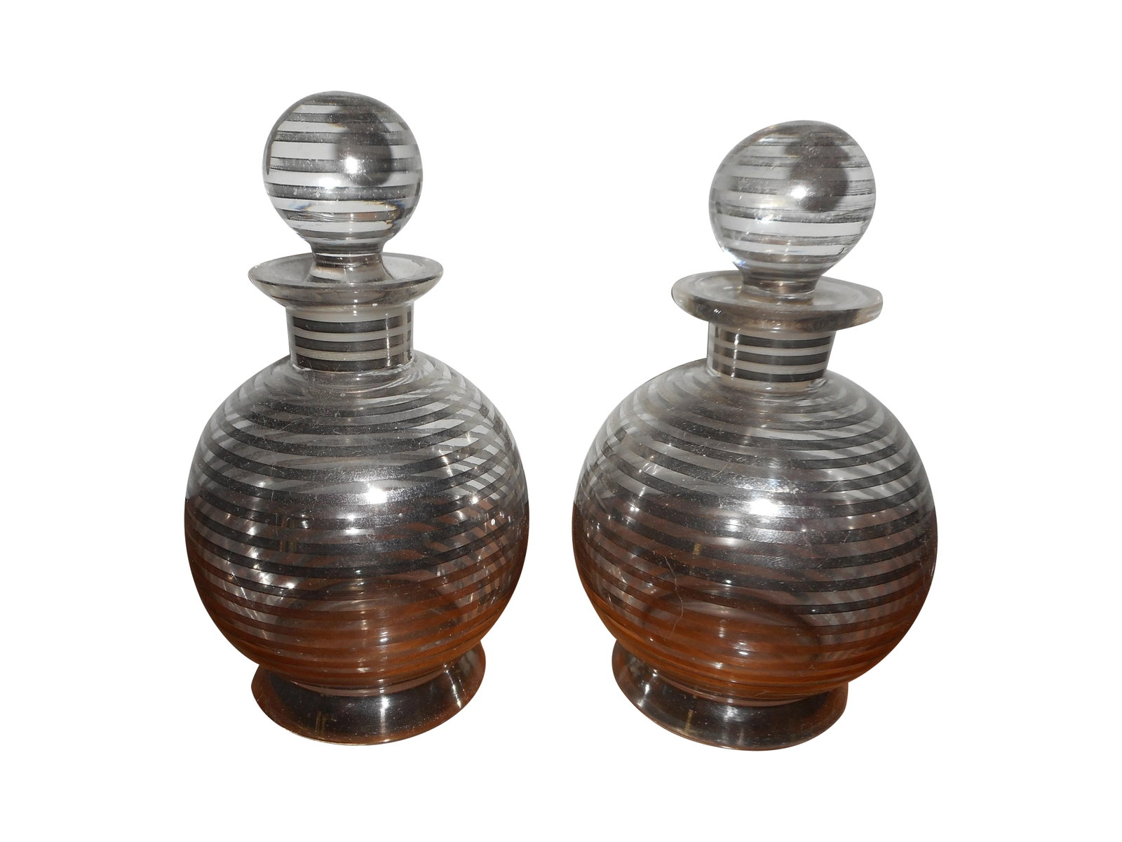 Sterling Silver Overlay Perfume Bottles - Pair: A pair of vintage perfume bottles from the 50s. These feature beautiful silver overlay on clear glass. One stopper has 2 small chips on the inside. Bottom of bottles are marked, appears to be "16" Con
