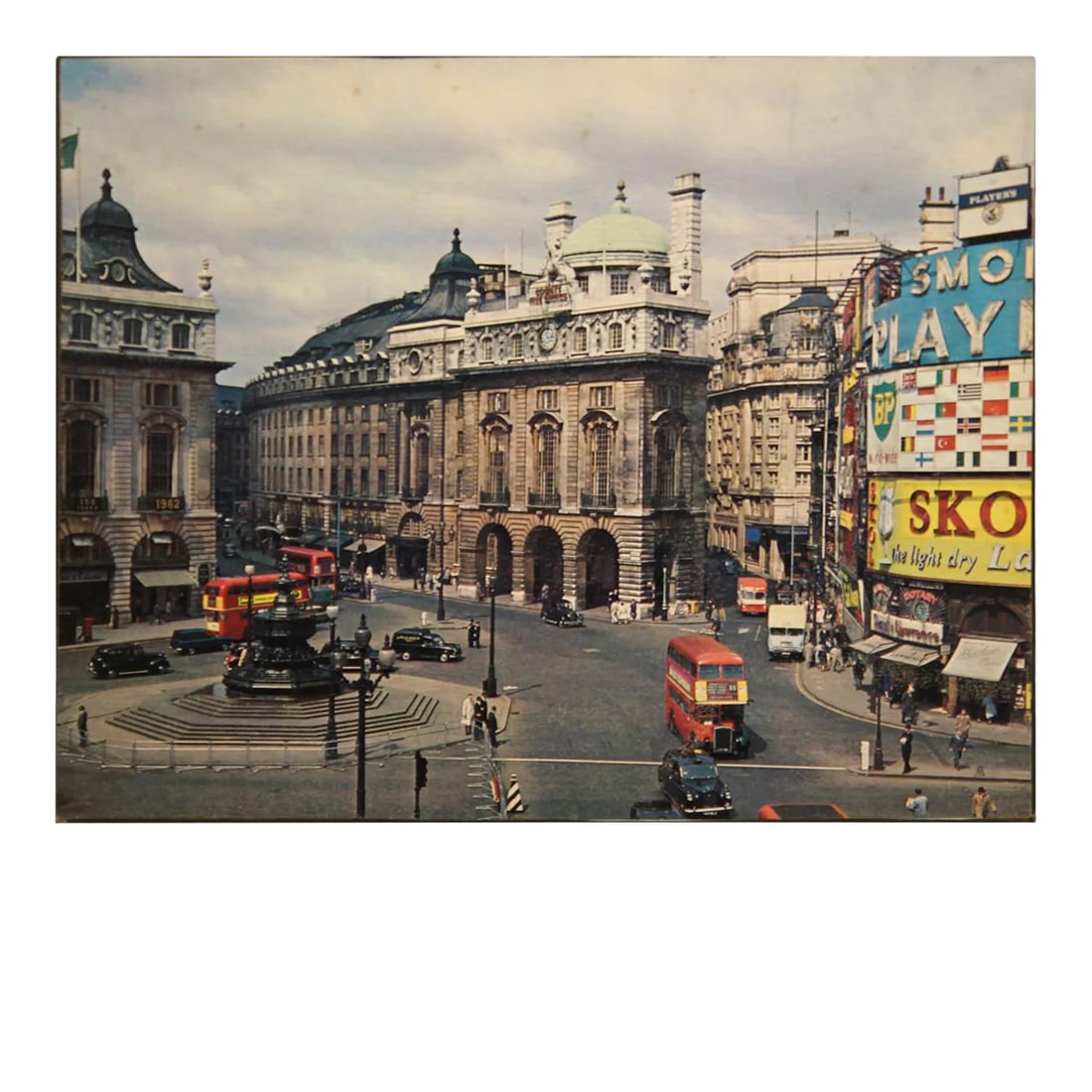 Mid Century Colored Piccadilly Circus Plaza Street Scene Photograph London, England: Colored photograph of a Plaza street scene in London. The photograph is matted to a thick board to protect against bending. The work is not framed. Condition: Alterations: Unknown Imperfections: Some 