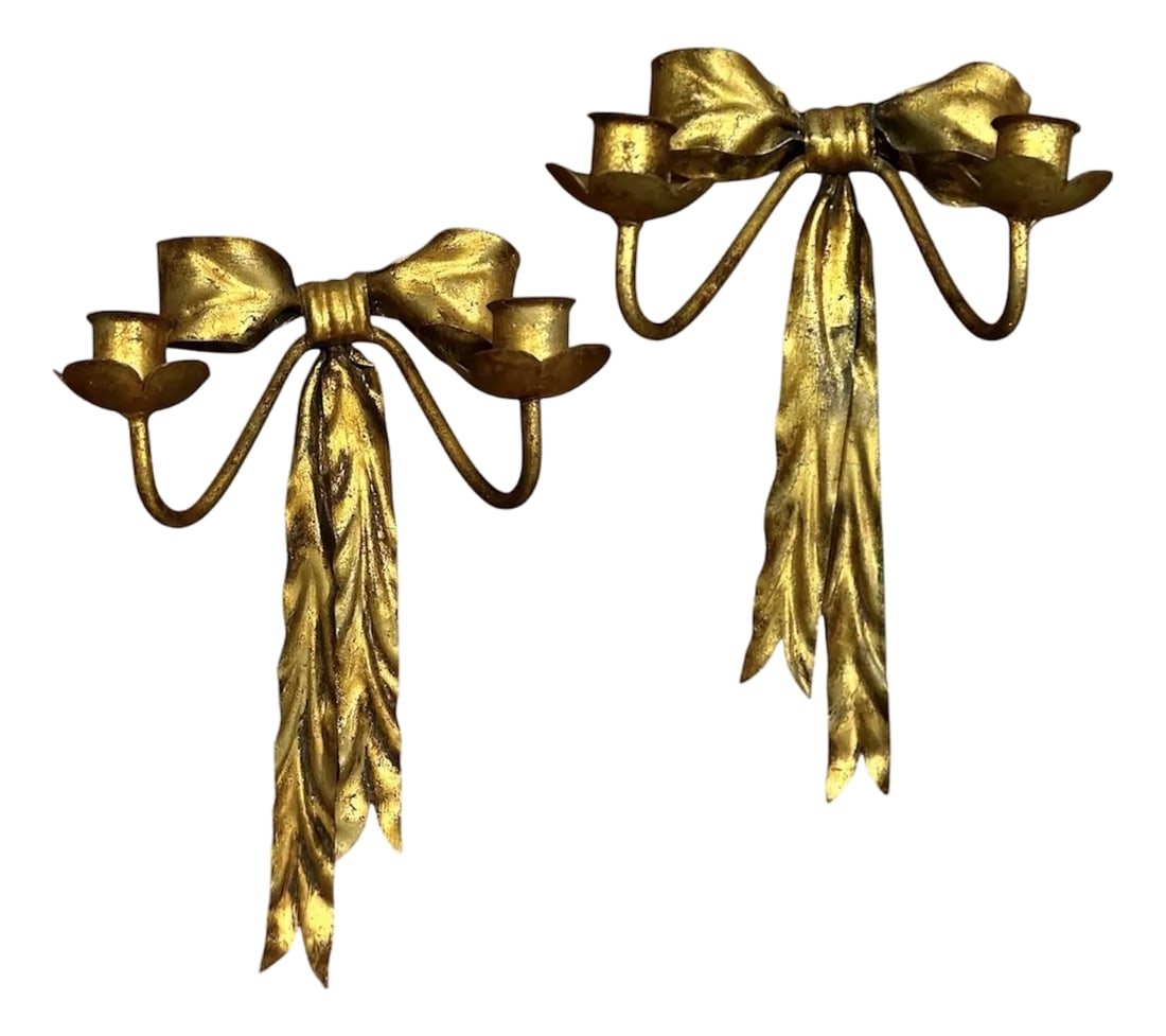 Vintage Italian Gilt Tole Gold Bow Wall Sconces / Candle Holders, a Pair: A charming pair of vintage tole wall sconce/candle holders. Each features a handmade bow form base adorned with trailing ribbons and a pair of floral candle cups. Finished with a hand applied gilt fin