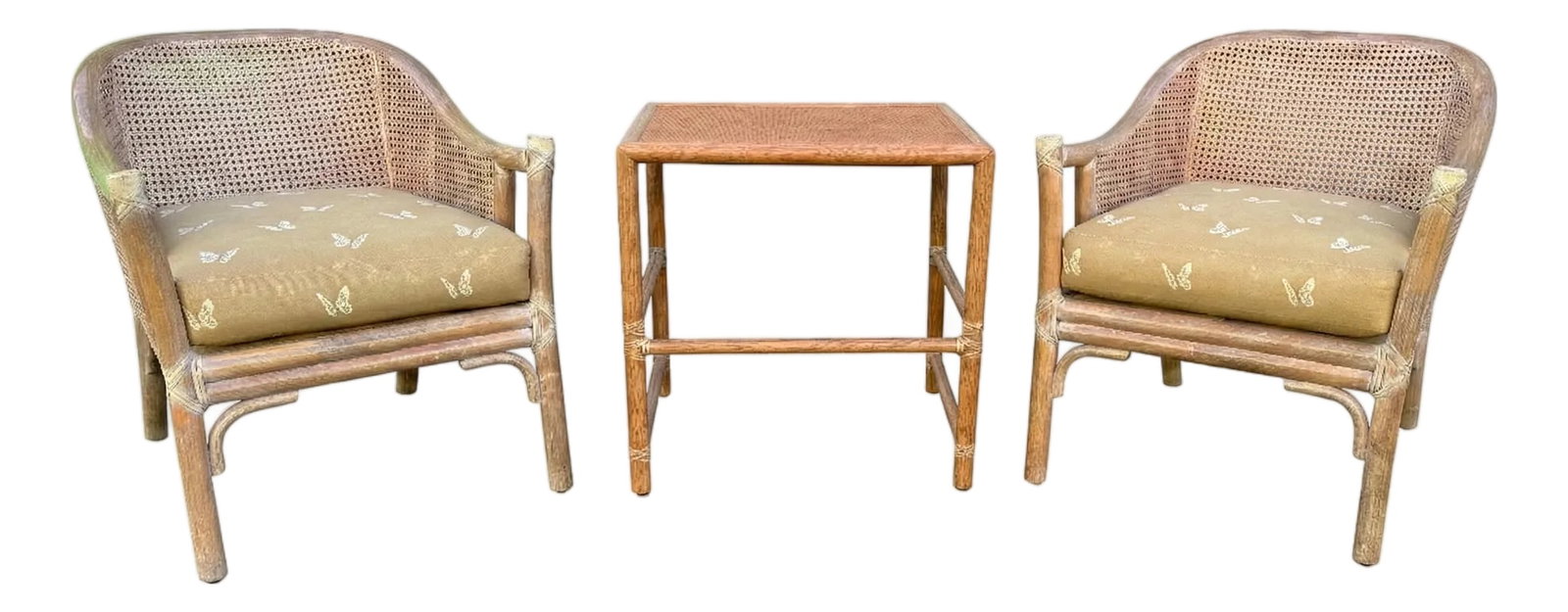 Pair of McGuire Cane & Rattan Chairs With Side Table, Late 20th Century: This exquisite three-piece seating set by McGuire effortlessly blends organic textures with elegant design. The set features two classic barrel-back lounge chairs and a matching side table, all