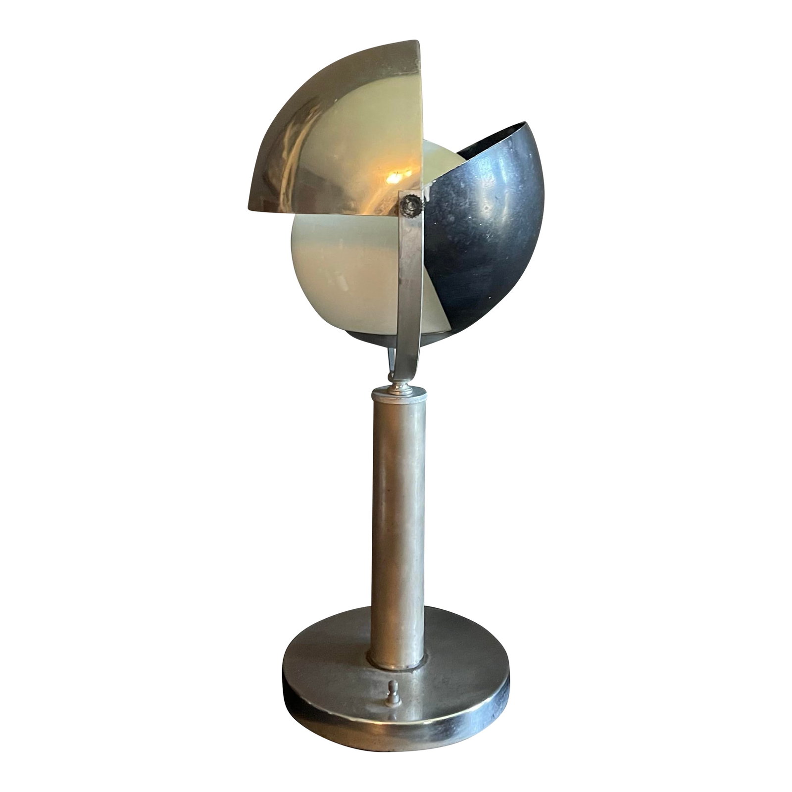 Mid 20th Century Space Age-Inspired Sculptural Table Lamp: A sculptural mid-century modern table lamp defined by its architectural clarity and adjustable, petal-style shade. Crafted from brushed aluminum, the lamp rises from a weighted circular base into a