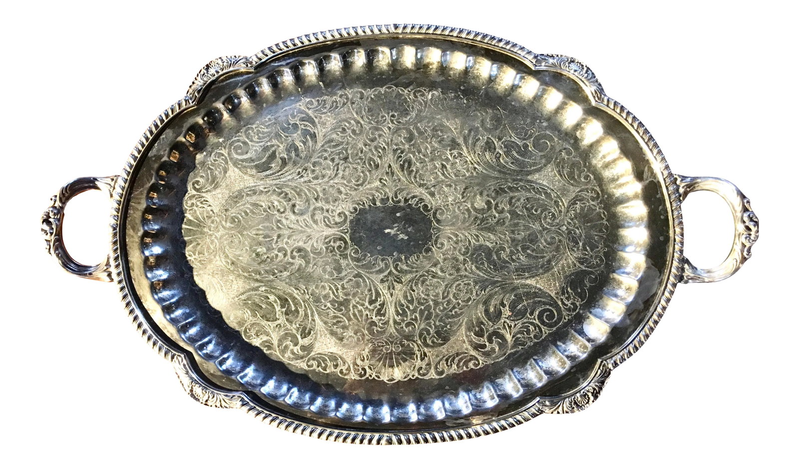 27" Silver Platter by Pilgrim: Stunning vintage silver plated serving tray with intricate etching on the platter portion and baroque detail on handles, edges, and feet. Note: Can be polished if desired. Dimensions: 27" x 16.5" x 1.
