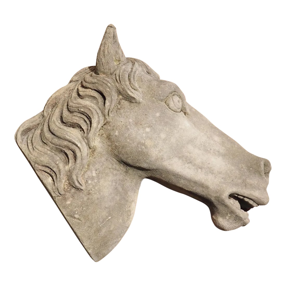 Carved Limestone Horsehead From Italy: Hand-carved by an Italian stone mason, this quaint limestone horsehead has excellent proportions. The contour of the cheek, the thick mane, and the slightly open mouth give the head a sense of realism