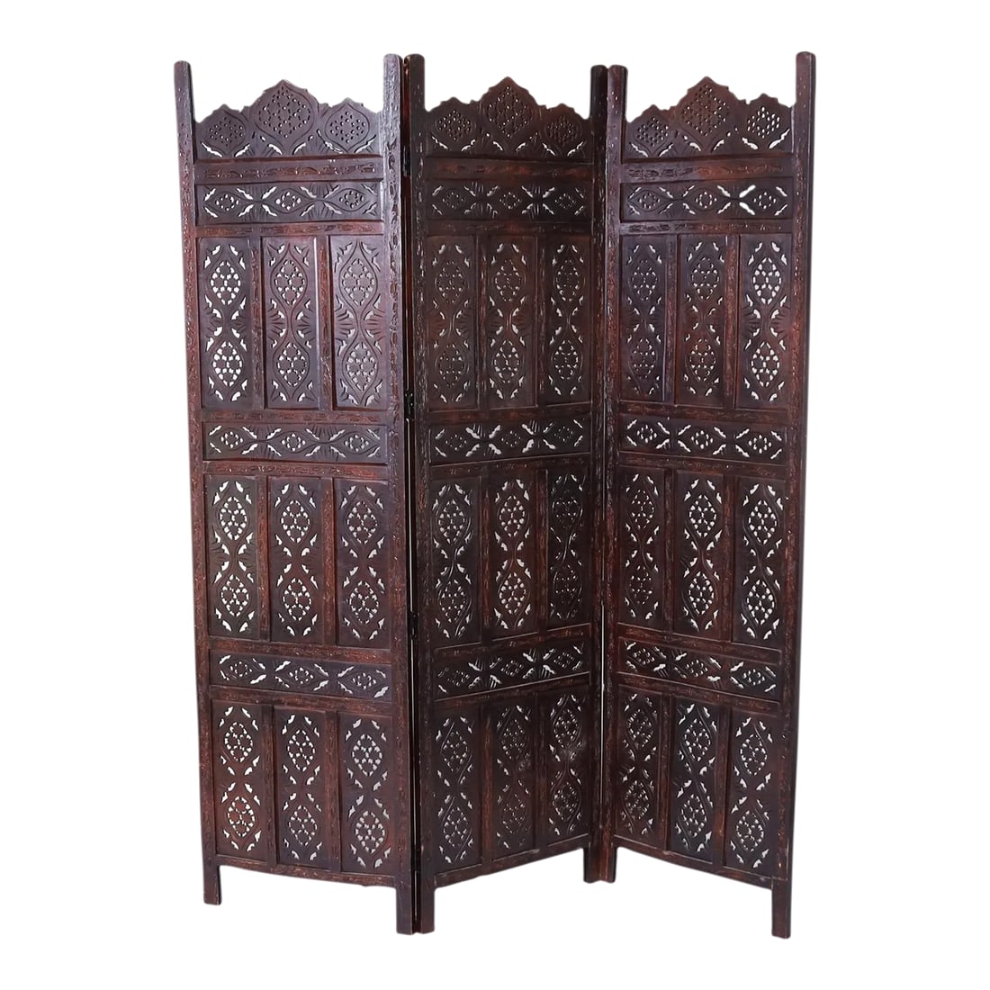 1960s Anglo Indian Carved Wood Three Panel Folding Screen: Vintage Anglo Indian folding three panel screen crafted in mahogany with floral carvings on the frames supporting open fretwork panels. Condition: Alterations: Unknown Imperfections: Some Imperfection