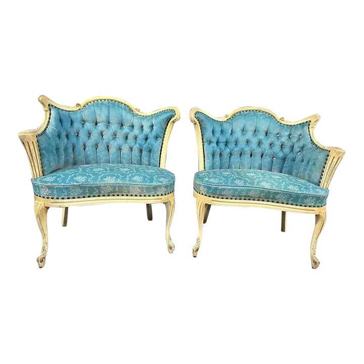 Early 20th Century Vintage Pair French Provincial Bergere Chairs: A true Right and Left set of bergere chairs with off-white carved and painted frame. Upholstered in a turquoise blue damask fabric. Each chair is 32"W x 34"T. Seat Height is 17". Condition: