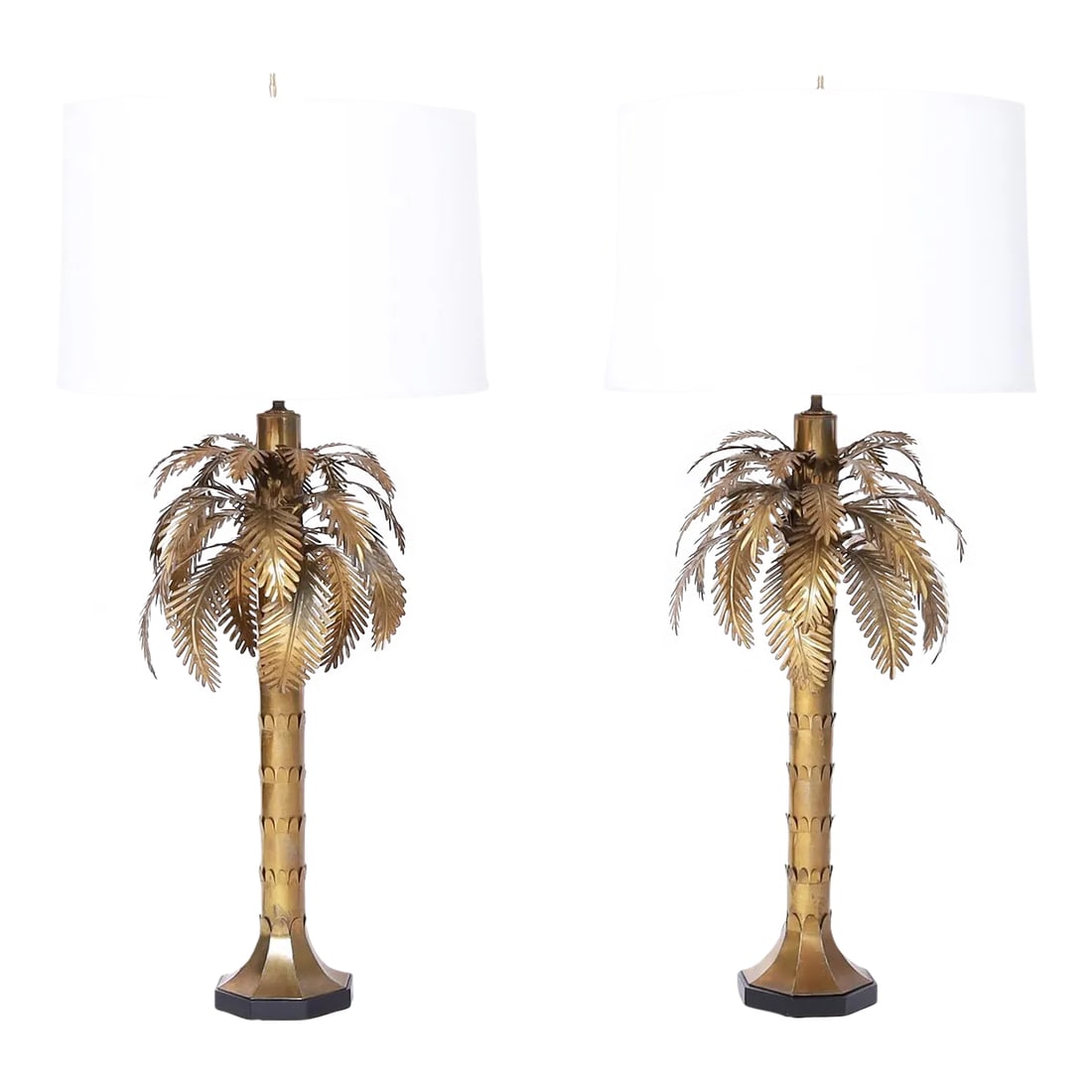 Pair of Brass Palm Tree Table Lamps: Chic mid century modern pair of table lamps crafted in brass in a stylized palm tree form on an octagon ebonized wood base. Best of the genre. Condition: Alterations: Restored Imperfections: Some
