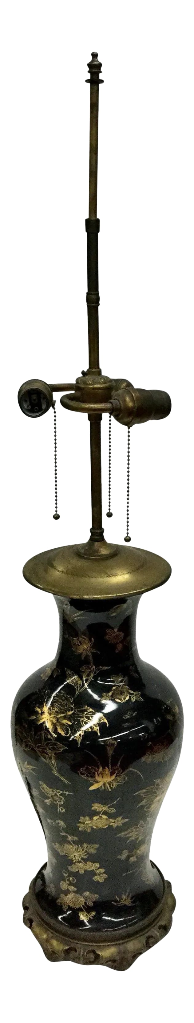 1960s Tall Chinese Porcelain Table Lamp: Build your room around this lamp. It will draw your eye to its magnificence. The rich gold over black with the Vintage brass hardware is absolutely stunning. 3 bulbs fit into individual sockets allowi