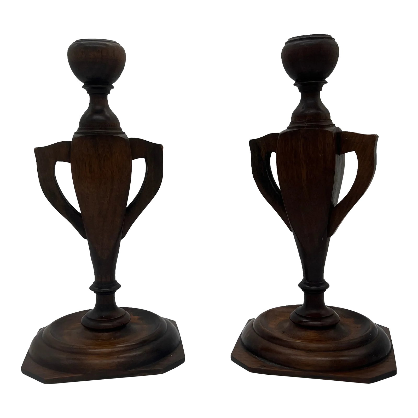 Pair, Arts & Crafts Trophy Urn Form Carved Wood Candlesticks Circa 1910: Likely American, circa 1910. A pair of carved wood possibly oak or walnut candlesticks in the form of trophy urns. Unmarked. Condition: Alterations: Original Condition Unaltered Imperfections: Some Im